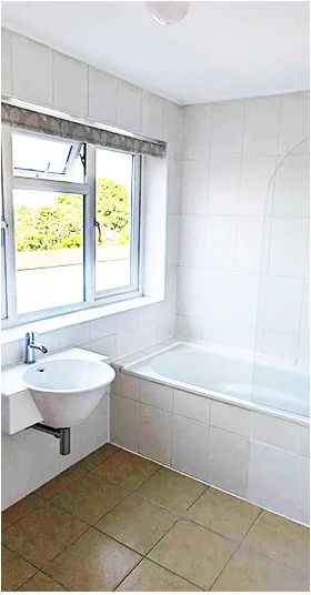 Clean white bathroom with a bath and basin